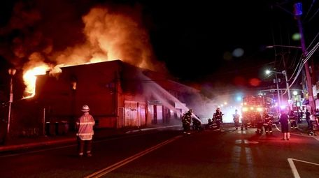 Firefighters battle a blaze at the corner of