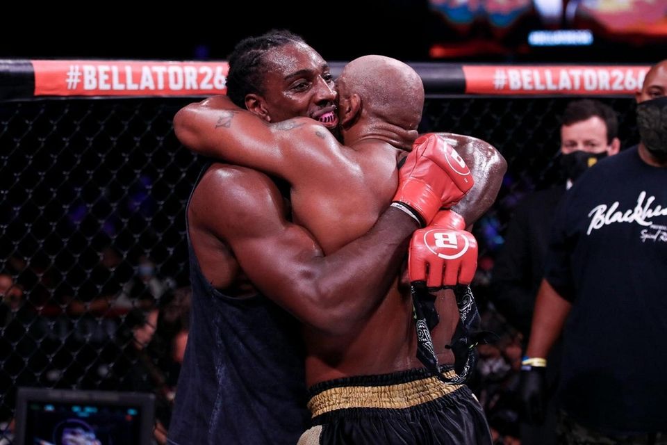 Phil Davis, left, and Yoel Romero embrace after