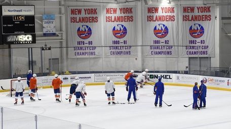Islanders players practice drills during training camp at