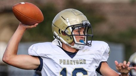 Bayport-Blue Point quarterback Brady Clark rolls out to