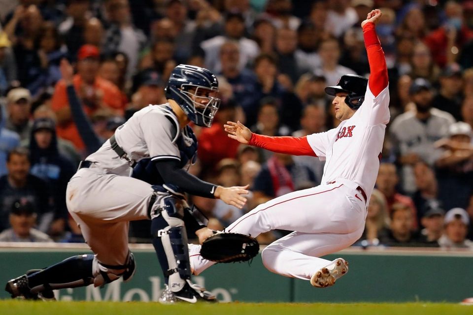 Boston Red Sox's Jose Iglesias, right, scores ahead
