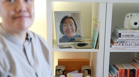 Jennifer Leung, in front of a photo of