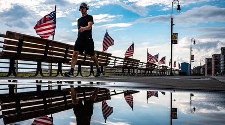 A man strolling on the boardwalk at Long