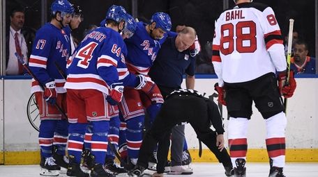 Rangers right wing Ryan Reaves is assisted off
