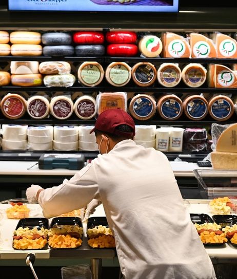 Cheese is prepared at the cheese counter inside