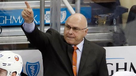 Islanders head coach Barry Trotz stands behind his