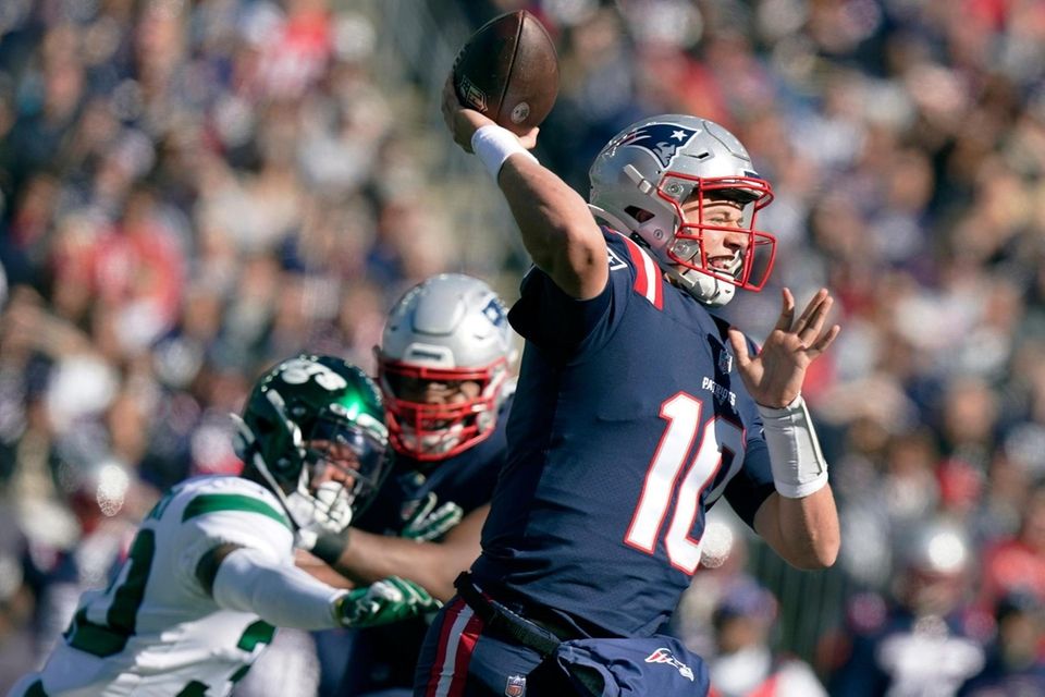New England Patriots quarterback Mac Jones (10) throws