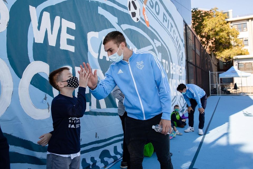 NYCFC's James Sands meets a student at the