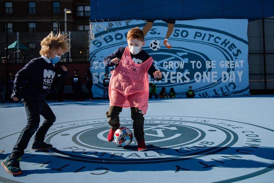 Children play at the unveiling of NYCFC's mini