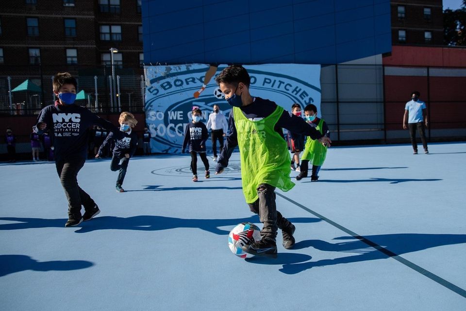 Children play at the unveiling of NYCFC's mini