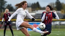 Carle Place's Alexandra Feit, left, clears the ball