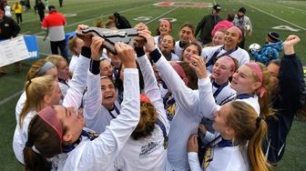 Massapequa celebrates with the championship plaque after their