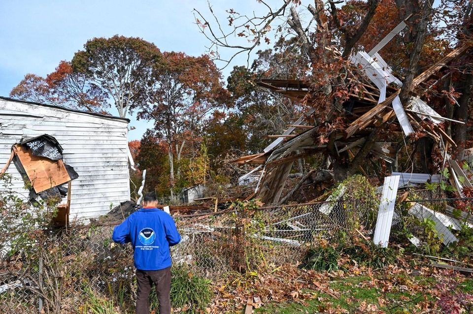 National Weather service meterologist Nelson Vaz, surveys damage