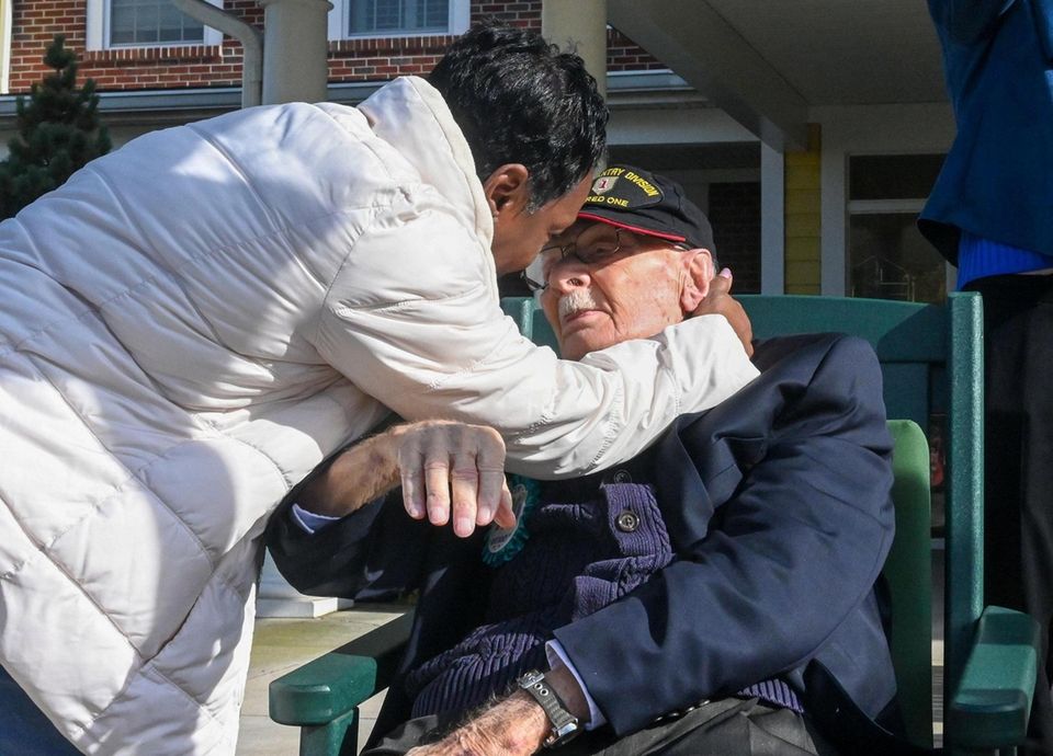 Army veteran Frank Wolff, 100, is embraced by