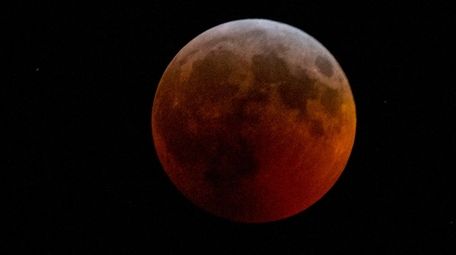 A total lunar eclipse, during which the moon