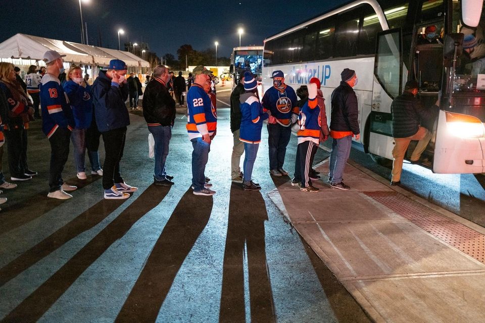 New York Islander fans board a shuttle bus
