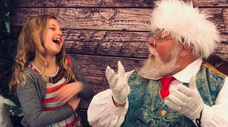 Reese Polansky, of Northport, meets Santa Claus at
