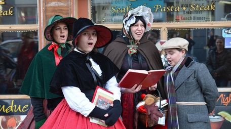 A group of holiday carolers serenade an audience