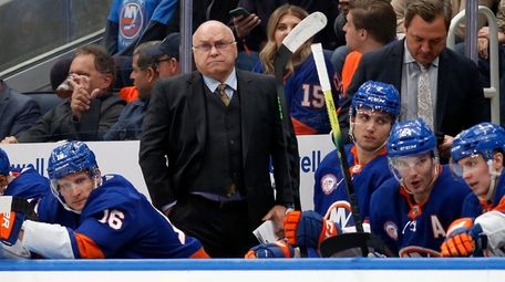 Islanders head coach Barry Trotz looks on from