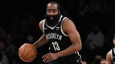 Nets guard James Harden dribbles the ball up