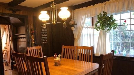 The dining room on the first floor has rustic wooden beams.