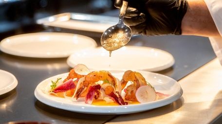 Chef Cesar Aguilar plates shrimp a la plancha