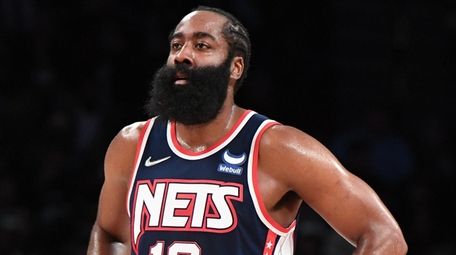 Nets guard James Harden looks on against the