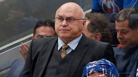 Islanders head coach Barry Trotz looks on from