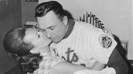 Mets manager Gil Hodges gets a kiss from