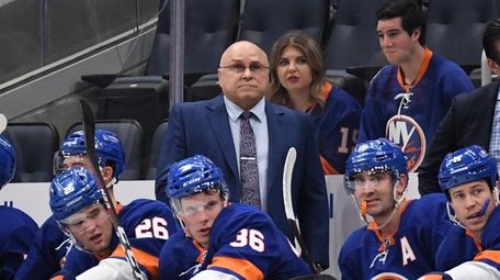 New York Islanders Barry Trotz looks on in