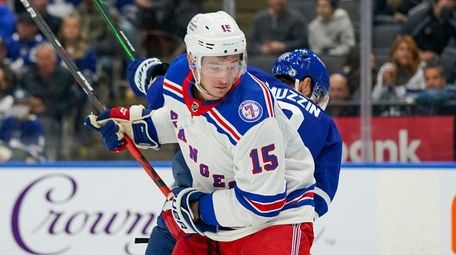 Rangers right wing Julien Gauthier (15) is tied