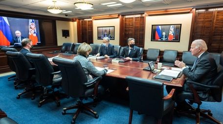 President Biden, right, during a videoconference with Russia's
