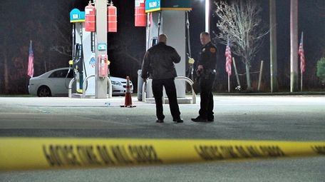Suffolk County police at a gas station where