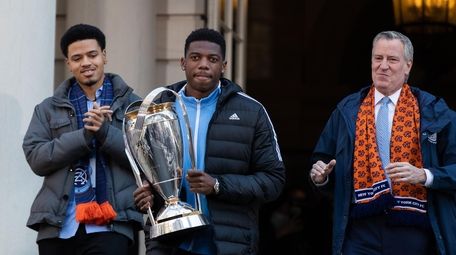 NYCFC captain Sean Johnson (center) carries the Philip
