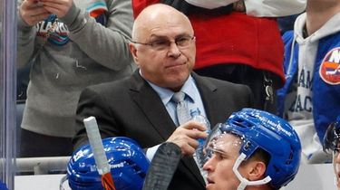Islanders head coach Barry Trotz looks on in
