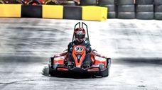 An electric go-kart racer stands by to make