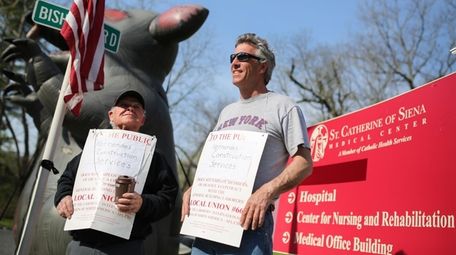 Union members picket over hiring practices outside Siena