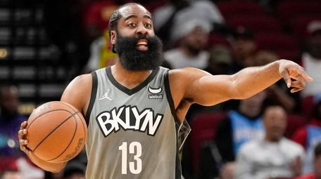 Nets guard James Harden gives instructions during the