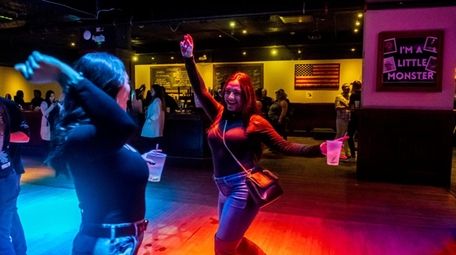 People dance as DJ Milli spins hit tunes