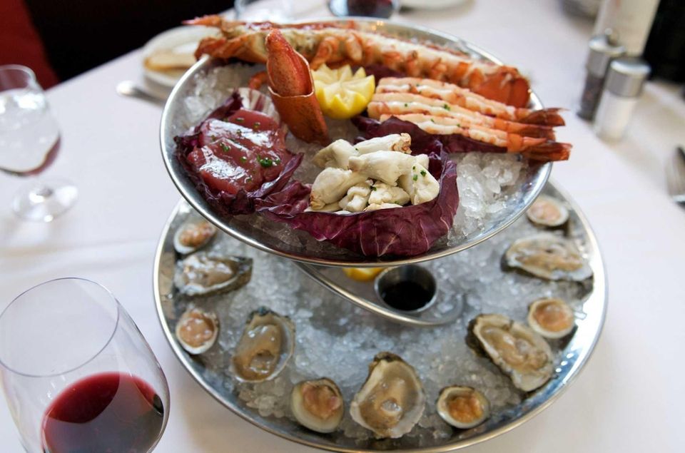 A seafood tower of oysters, clams, shrimp, tuna