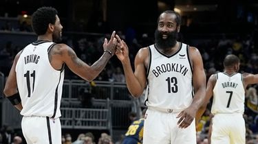 The Nets' Kyrie Irving and James Harden celebrate