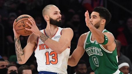 Knicks guard Evan Fournier looks to pass defended