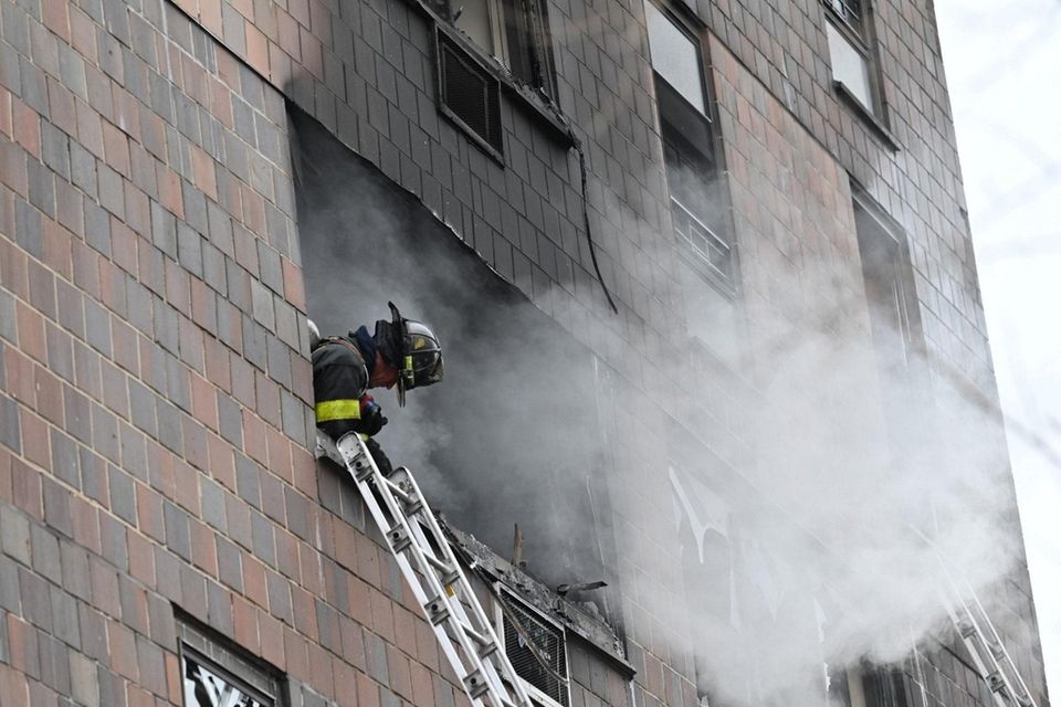 Firefighters battle multiple-alarm blaze in a high-rise residential