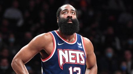 Nets guard James Harden looks on against the