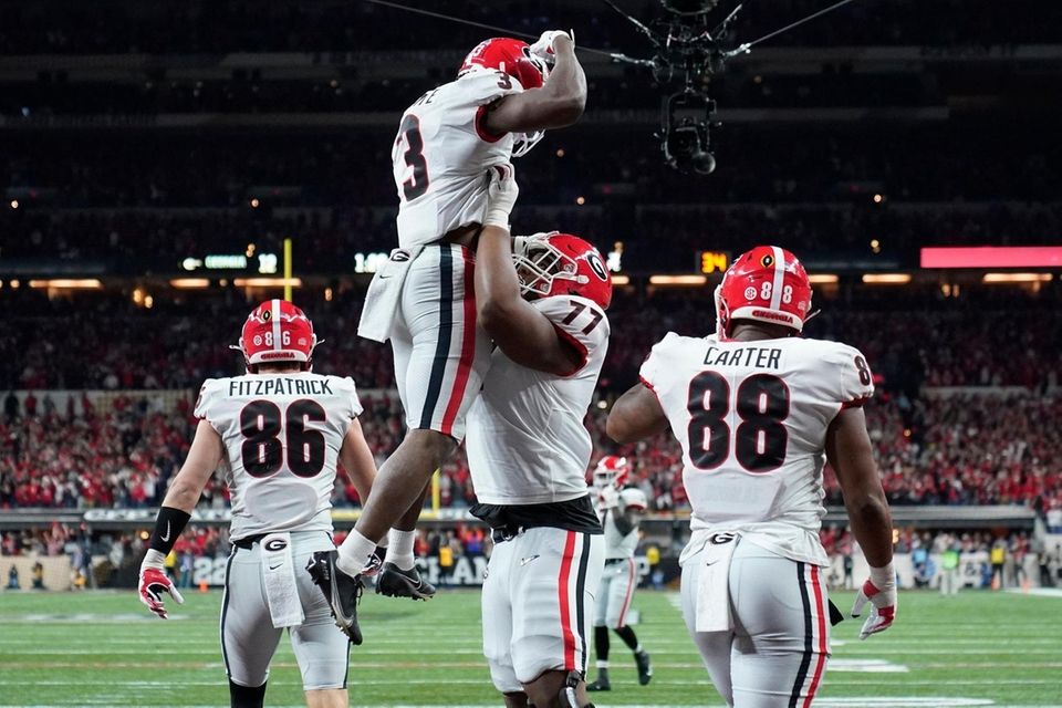Georgia's Zamir White is congratulated after running for