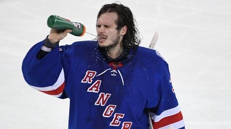 New York Rangers goaltender Igor Shesterkin hydrates during