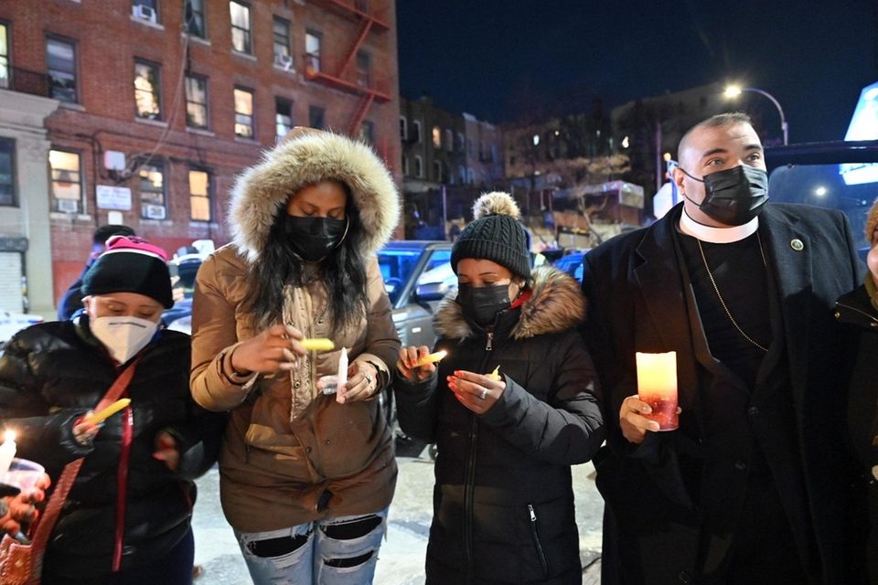 Community members hold a candlelight vigil on Tuesday,