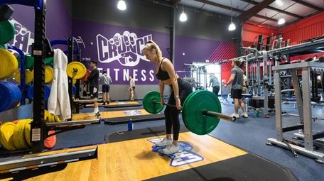 Amanda Pusateri of Massapequa lifts weights at Crunch