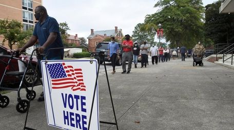 Voters wait in line to cast their ballot