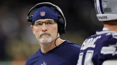 Cowboys acting head coach Dan Quinn walks the